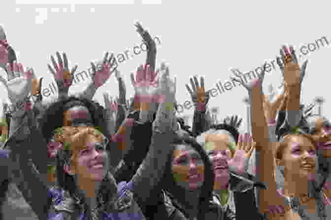 A Person Standing In Front Of A Large Group Of People, Raising Their Hand And Speaking Into A Microphone, Representing The Act Of Challenging The Political Establishment. After Democracy: Imagining Our Political Future